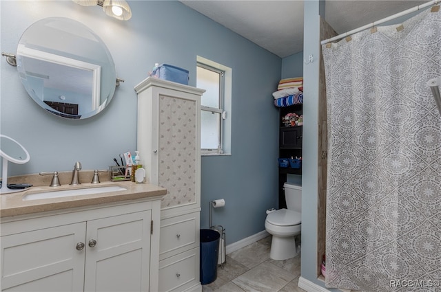 bathroom with a textured ceiling, vanity, toilet, and curtained shower