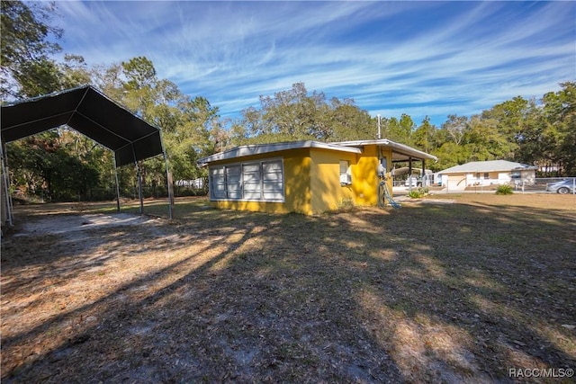 view of side of property with a carport