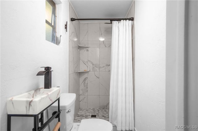 bathroom featuring toilet and walk in shower