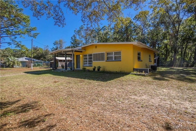 view of front of house featuring cooling unit and a front yard