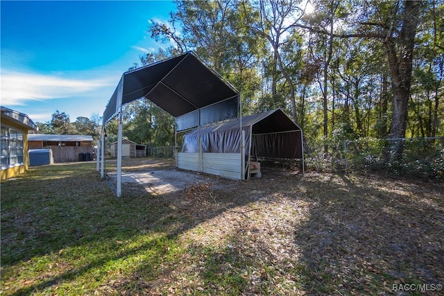 exterior space featuring a carport and an outbuilding