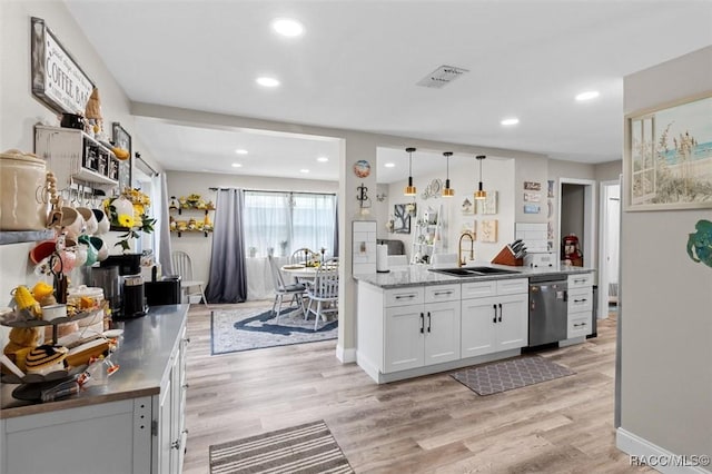 2 William Tell Ln, Beverly Hills, FL 34465 - kitchen with dishwasher, light wood-style flooring, white cabinets, recessed lighting, and pendant lighting