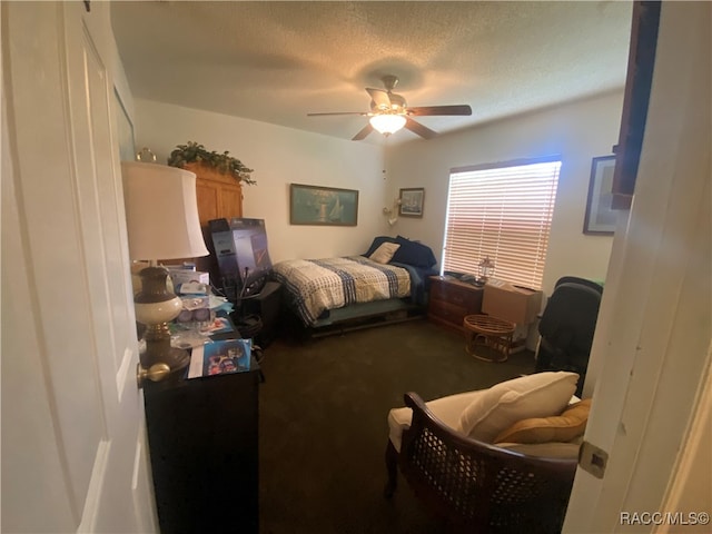 bedroom with carpet flooring, ceiling fan, and a textured ceiling