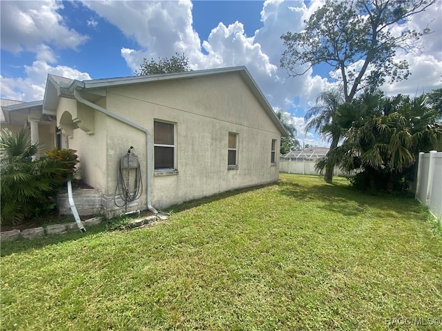 view of side of home featuring a lawn