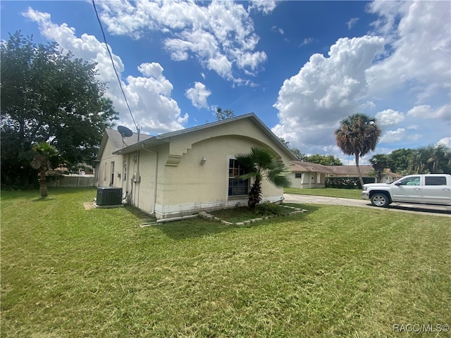 view of home's exterior with a yard and central AC unit