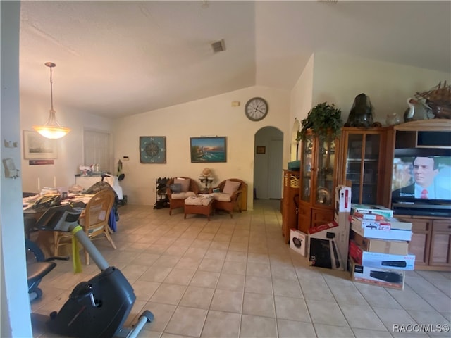 tiled living room featuring vaulted ceiling