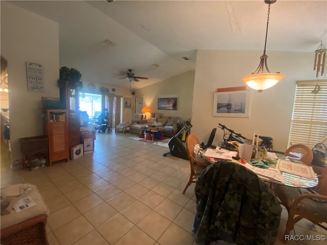 tiled dining area featuring ceiling fan and lofted ceiling