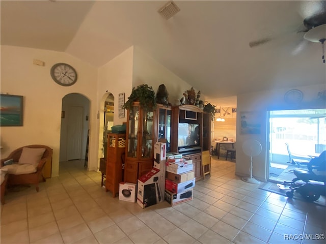 living room with light tile patterned floors, ceiling fan, and lofted ceiling