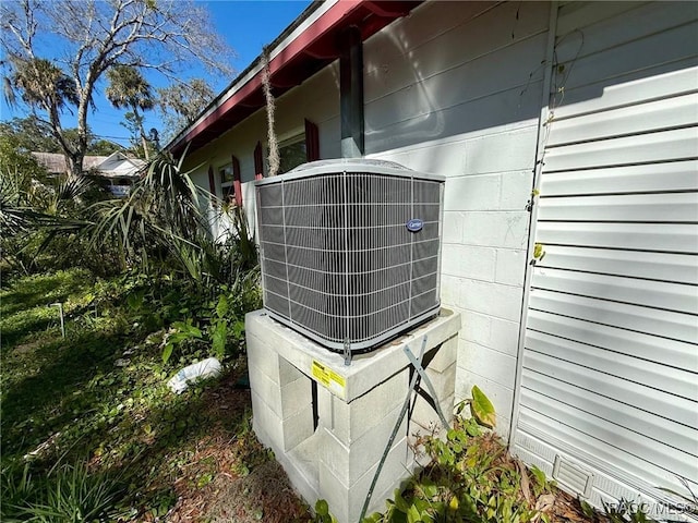 939 NE 4th Ave, Crystal River, FL 34428 - exterior view of cooling unit and concrete block siding