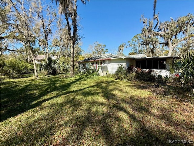 939 NE 4th Ave, Crystal River, FL 34428 - view of grassy yard featuring a sunroom