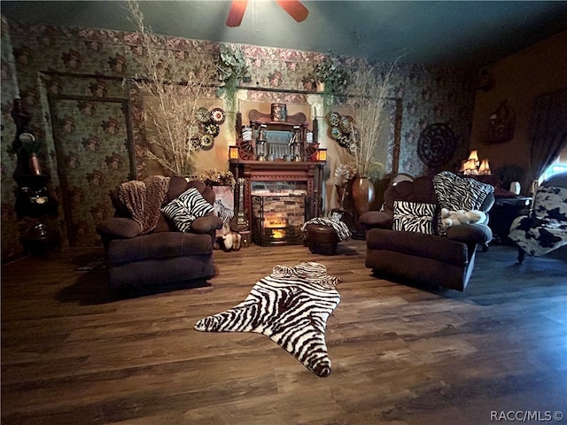 sitting room with ceiling fan and hardwood / wood-style floors