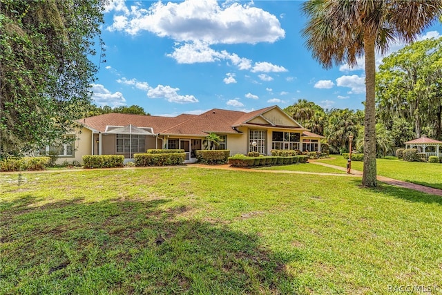 ranch-style home featuring a front yard