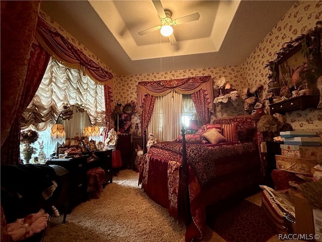 bedroom featuring a tray ceiling, ceiling fan, and light colored carpet