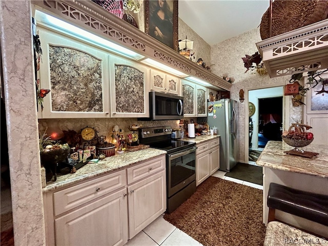 kitchen with light tile patterned flooring and appliances with stainless steel finishes