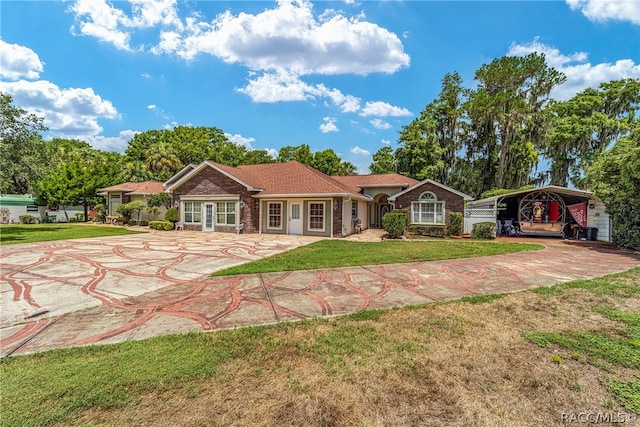 view of front of home with a carport and a front lawn