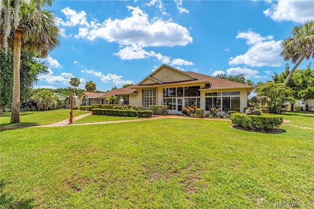 rear view of house with a yard