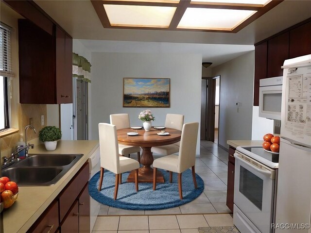 kitchen with light tile patterned flooring, sink, dark brown cabinets, white appliances, and decorative backsplash