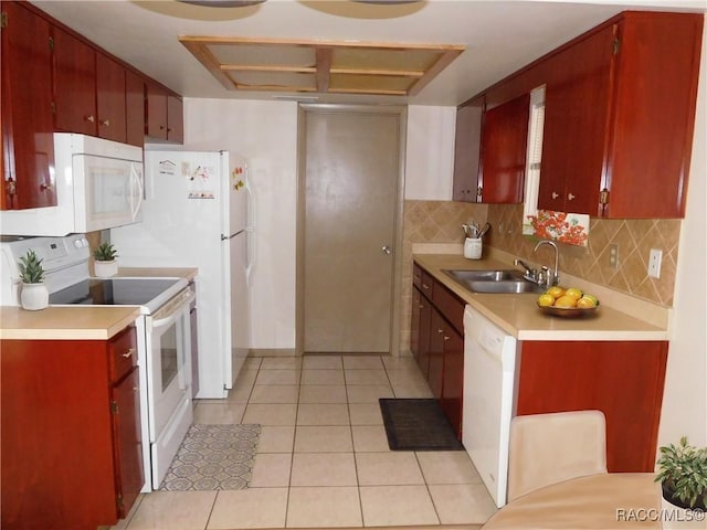 kitchen with tasteful backsplash, white appliances, light tile patterned flooring, and sink