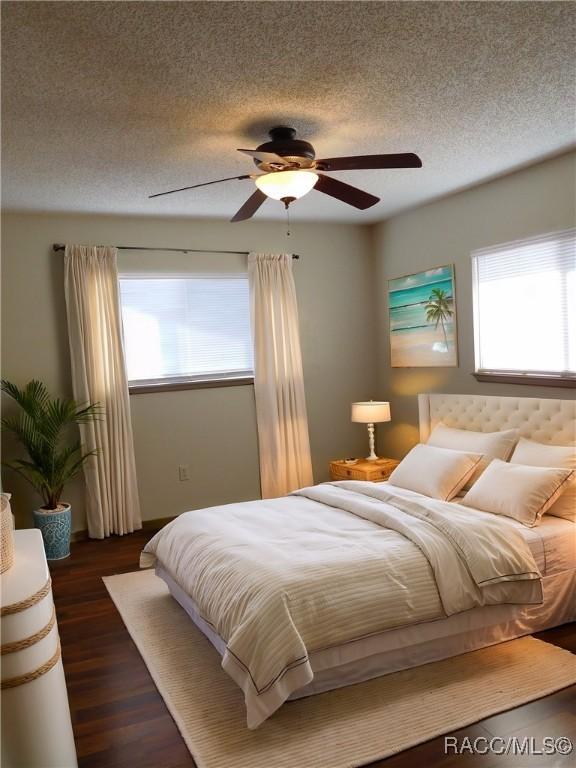 bedroom featuring ceiling fan, dark hardwood / wood-style floors, and a textured ceiling