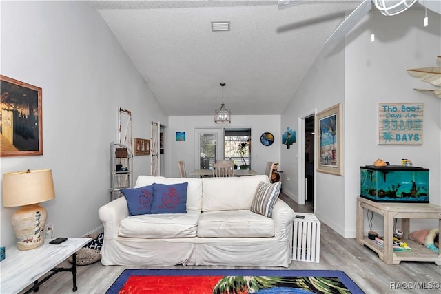 9844 SW 198th Cir, Dunnellon, FL 34432 - living area featuring a ceiling fan, wood finished floors, baseboards, lofted ceiling, and visible vents