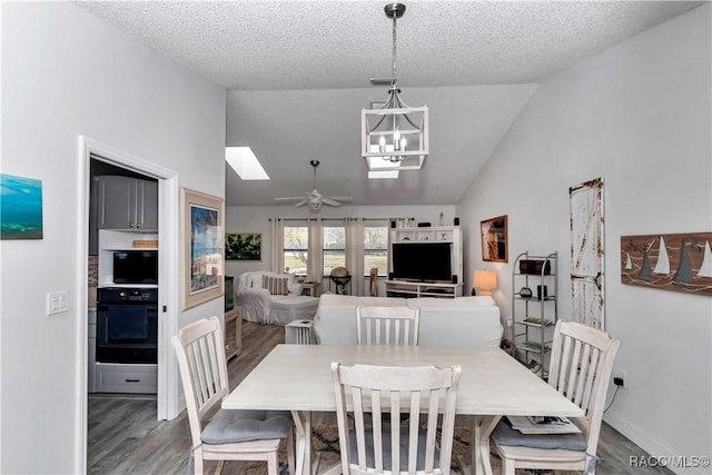 9844 SW 198th Cir, Dunnellon, FL 34432 - dining space featuring ceiling fan with notable chandelier, wood finished floors, high vaulted ceiling, and visible vents