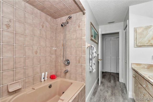 9844 SW 198th Cir, Dunnellon, FL 34432 - bathroom with bathing tub / shower combination, wood finished floors, visible vents, vanity, and baseboards