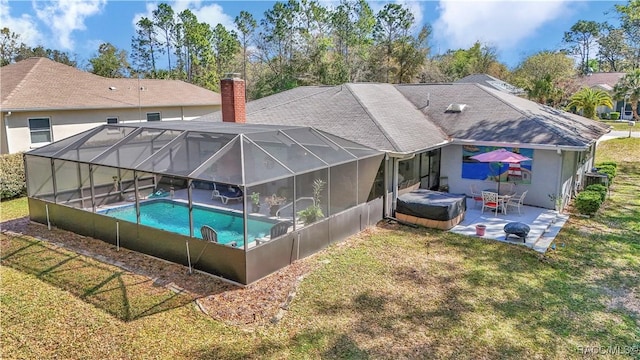 9844 SW 198th Cir, Dunnellon, FL 34432 - back of property featuring a chimney, an outdoor pool, a patio area, and a lawn