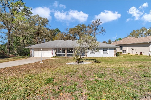 9844 SW 198th Cir, Dunnellon, FL 34432 - single story home featuring concrete driveway, a front lawn, a garage, and covered porch