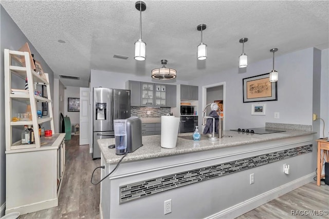9844 SW 198th Cir, Dunnellon, FL 34432 - kitchen with a peninsula, a textured ceiling, light wood-type flooring, gray cabinets, and black appliances