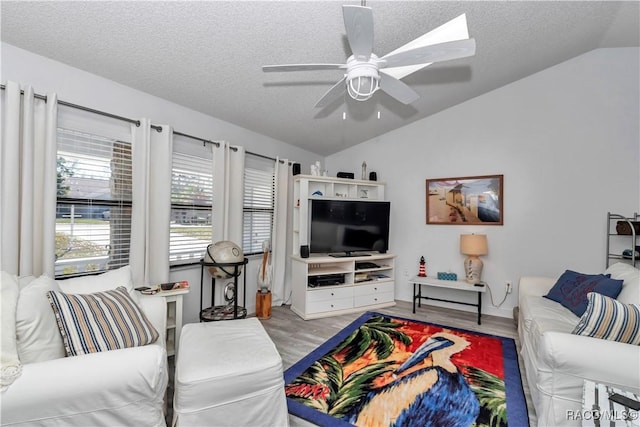 9844 SW 198th Cir, Dunnellon, FL 34432 - living area featuring vaulted ceiling, wood finished floors, a textured ceiling, and ceiling fan