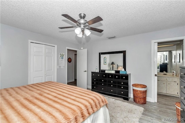 9844 SW 198th Cir, Dunnellon, FL 34432 - bedroom featuring a closet, wood finished floors, visible vents, and a textured ceiling