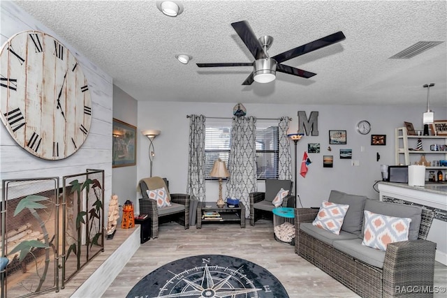 9844 SW 198th Cir, Dunnellon, FL 34432 - living room with light wood-style flooring, visible vents, a textured ceiling, and ceiling fan