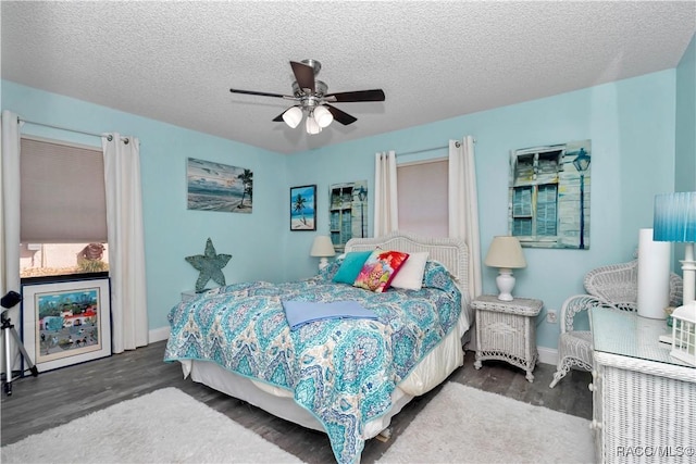 9844 SW 198th Cir, Dunnellon, FL 34432 - bedroom featuring baseboards, a ceiling fan, wood finished floors, and a textured ceiling