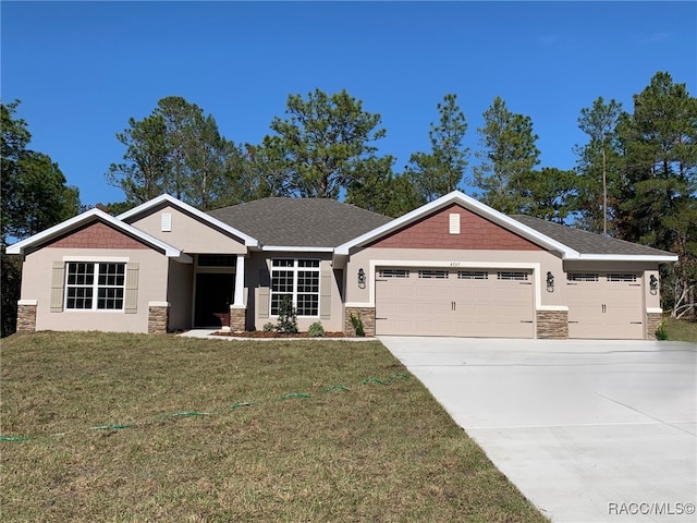 craftsman house with a garage and a front lawn