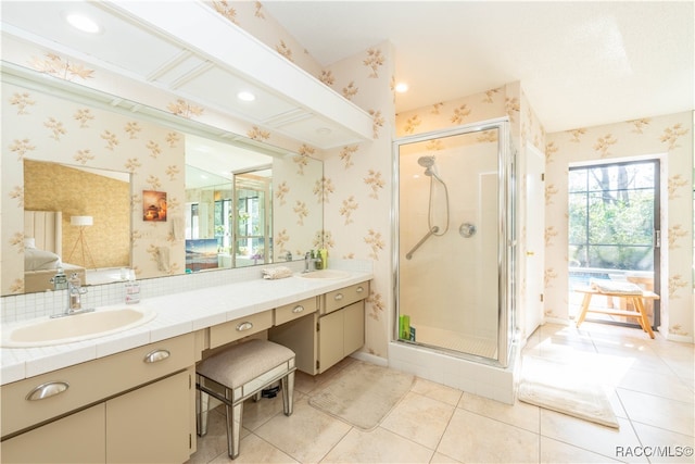 bathroom featuring tile patterned floors, vanity, and a shower with shower door