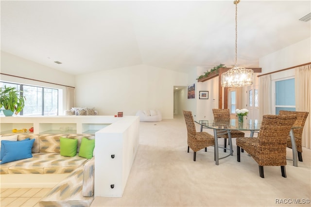 carpeted bedroom featuring lofted ceiling and a notable chandelier