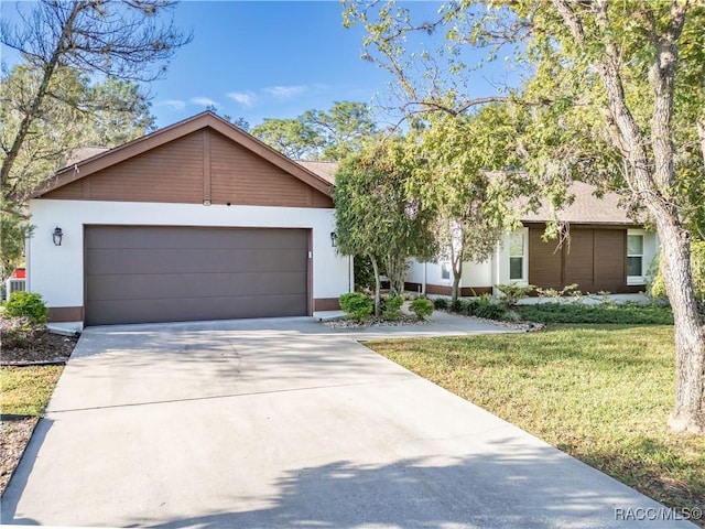 ranch-style house featuring a garage and a front yard