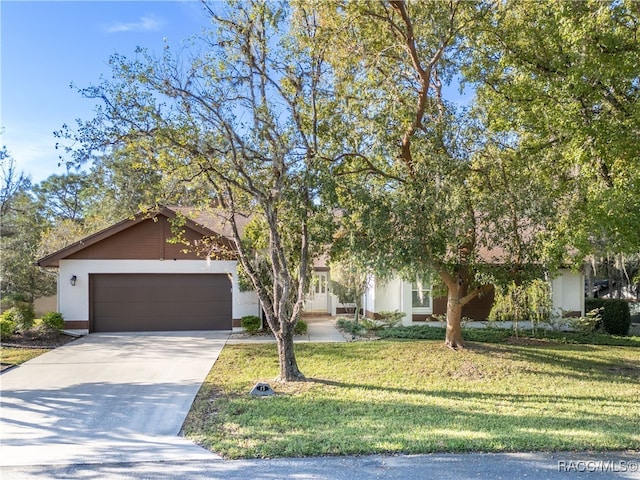 obstructed view of property with a garage and a front yard