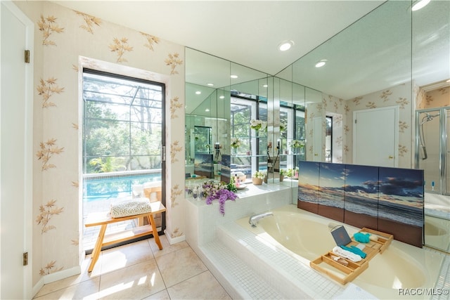 bathroom with tiled tub and tile patterned floors