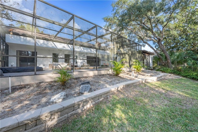 view of yard featuring a patio area and glass enclosure