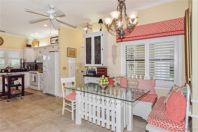 dining room with ceiling fan with notable chandelier, crown molding, and light tile patterned flooring