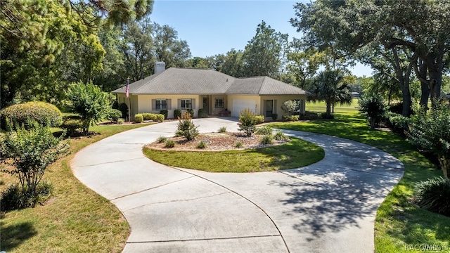 ranch-style house with a garage and a front yard