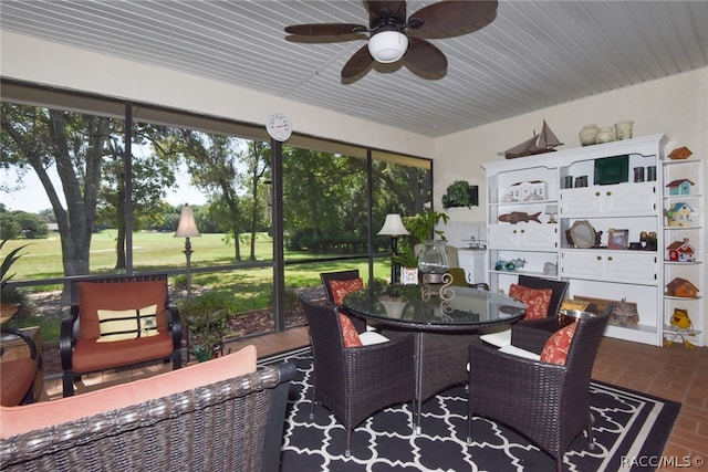 sunroom / solarium featuring ceiling fan