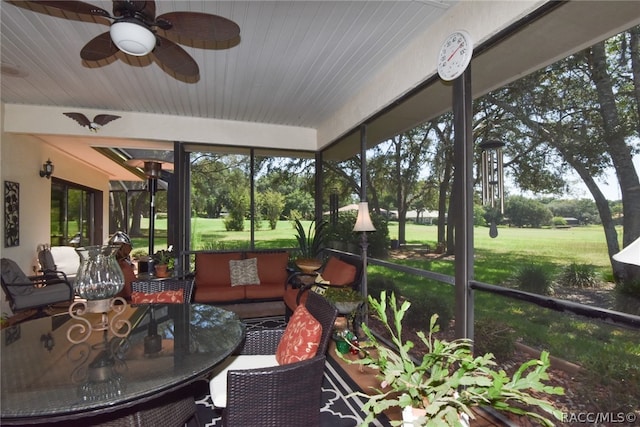 sunroom / solarium featuring ceiling fan