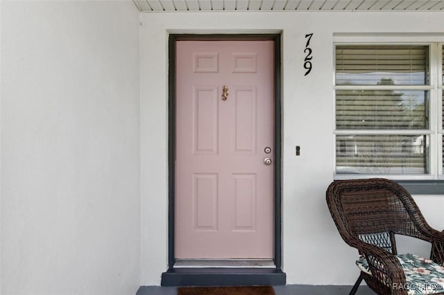 property entrance with stucco siding