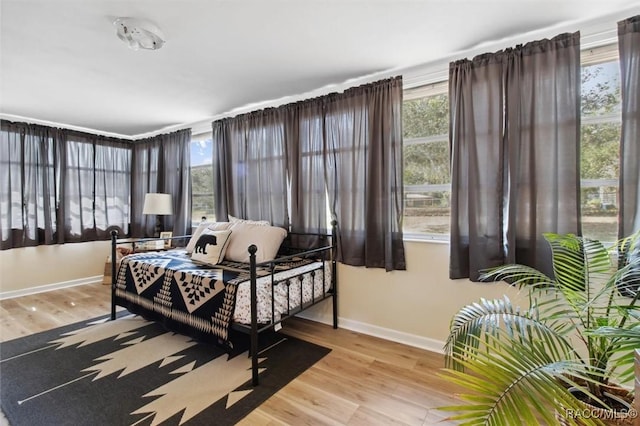 bedroom featuring light wood-style flooring and baseboards