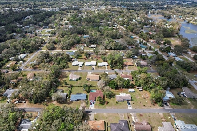 birds eye view of property with a water view and a residential view