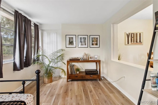 interior space featuring light wood-type flooring and baseboards