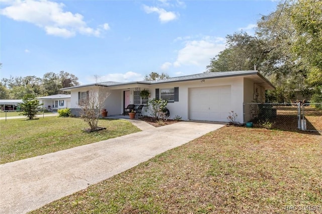 single story home with a garage, fence, driveway, stucco siding, and a front yard