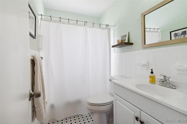 full bath with toilet, tile walls, shower / bath combination with curtain, and vanity